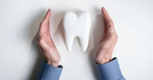 Hands Cradling Fake Tooth